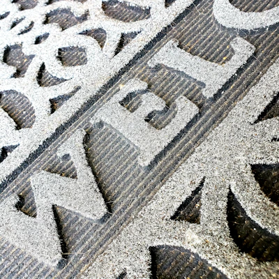 A cozy home door mat featuring a personalized family name in classic script.
