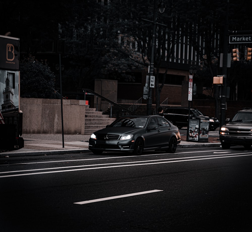 a couple of cars that are sitting in the street