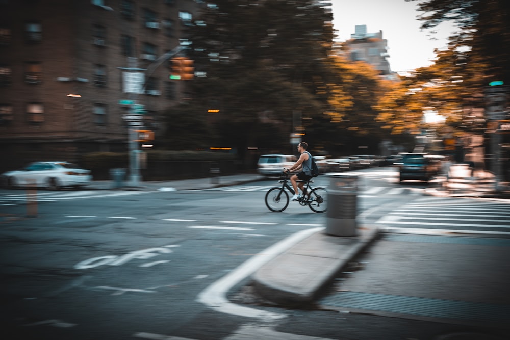 man riding bicycle on road during daytime