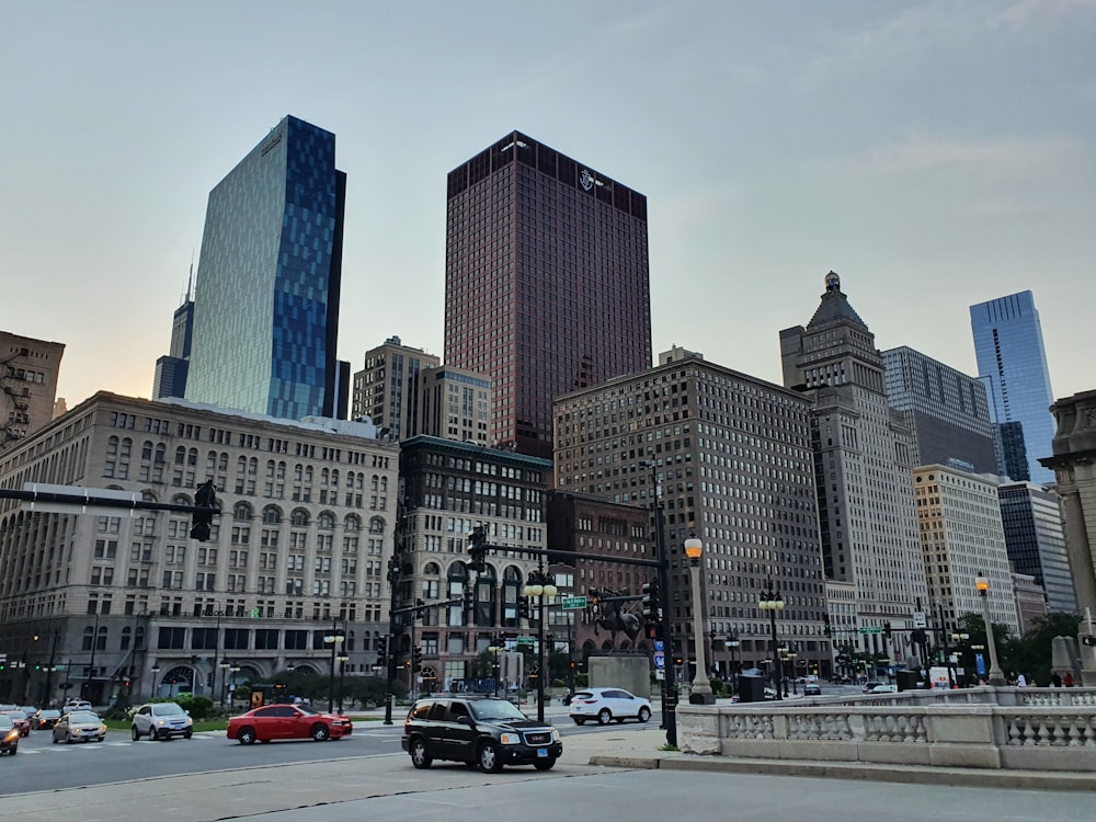 cars on road near high rise buildings during daytime