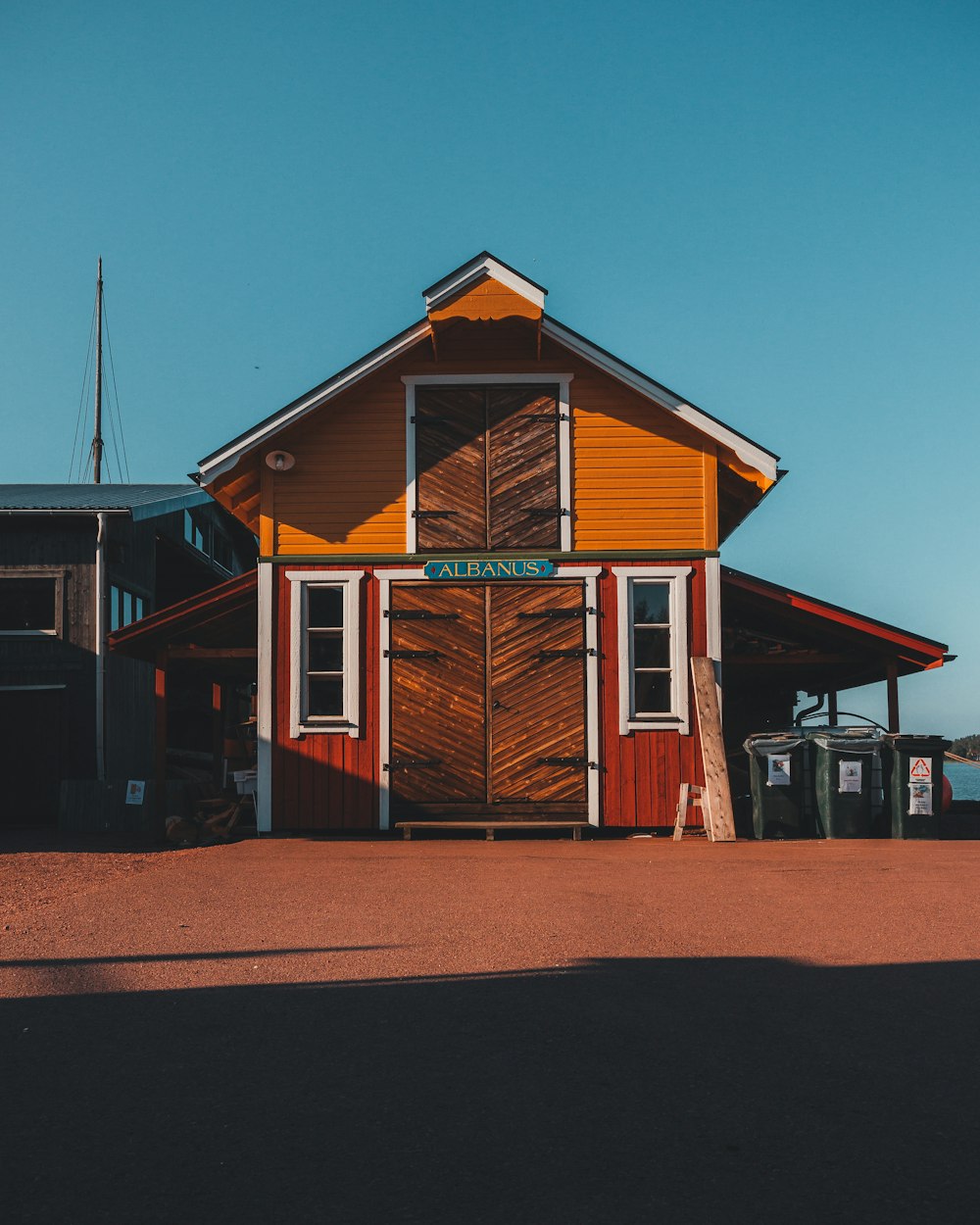 brown and white wooden house under blue sky during daytime