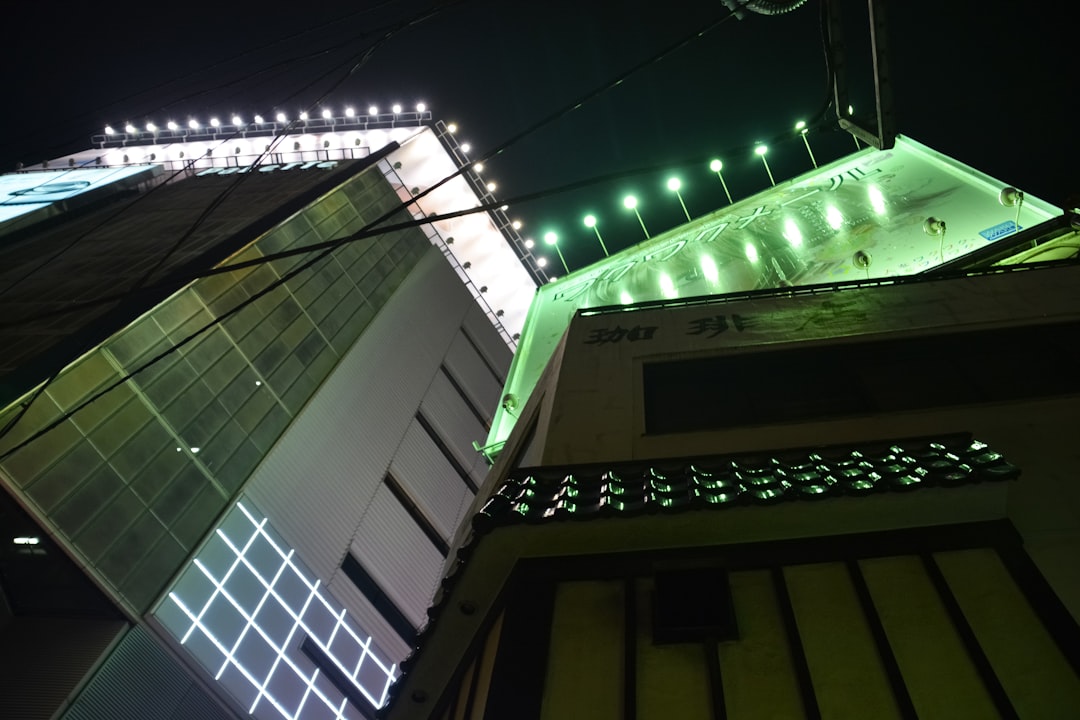 green string lights on white concrete building