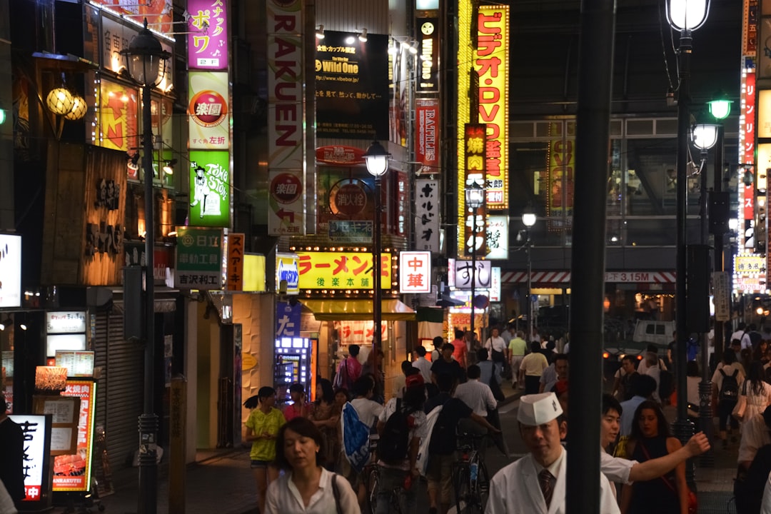 people sitting on chair near store during night time