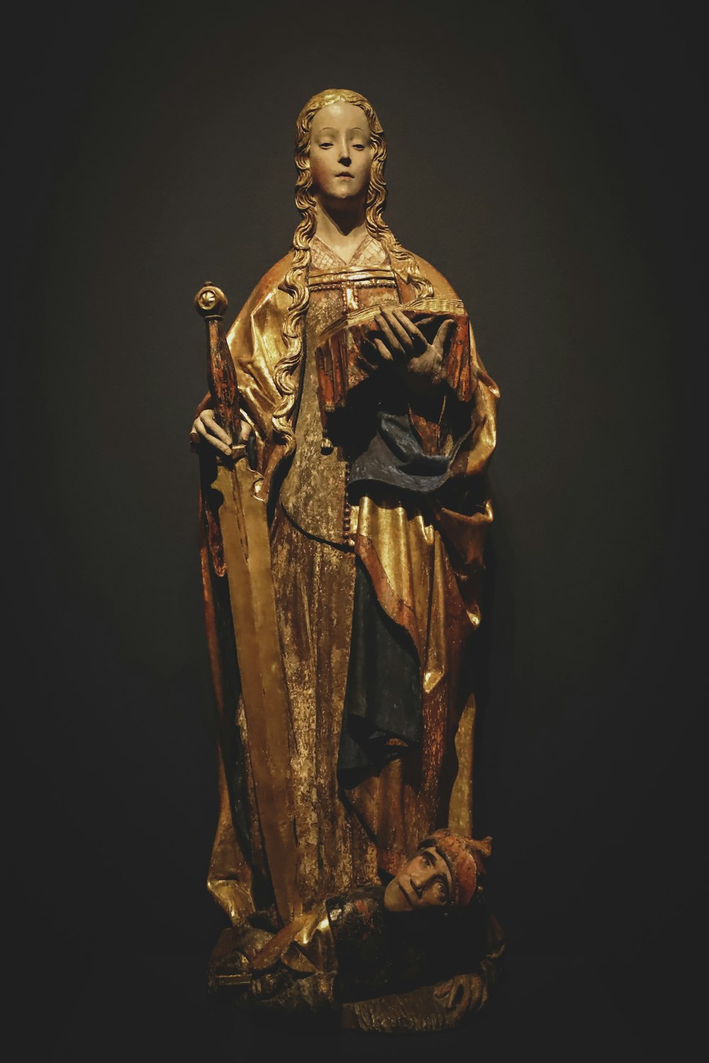 man in brown robe statue