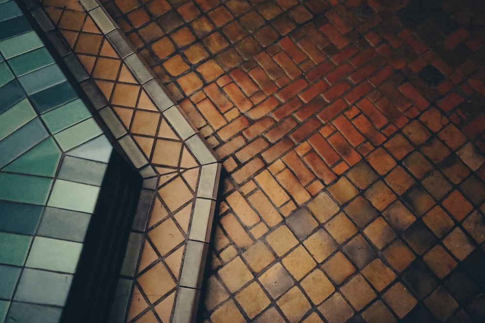 brown brick floor beside black framed glass window