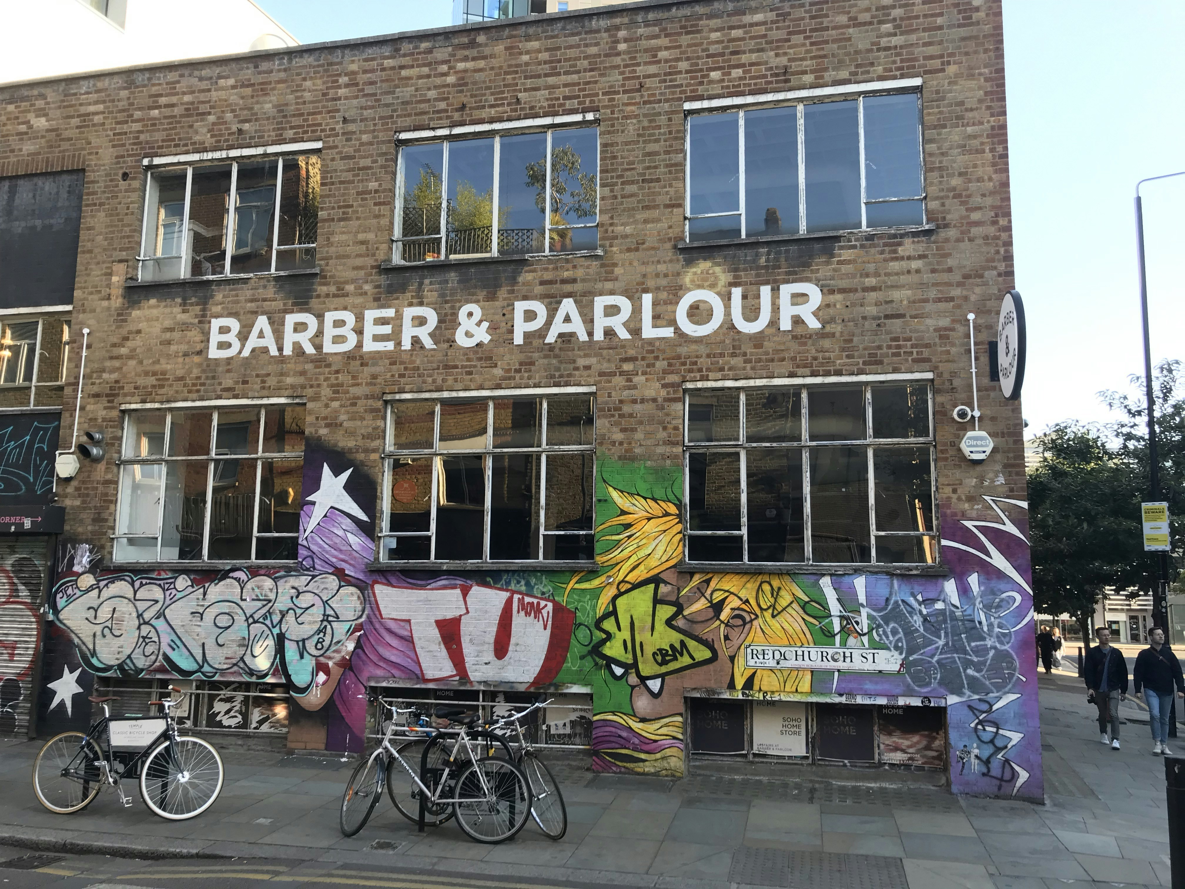 woman in purple dress sitting on black steel bench