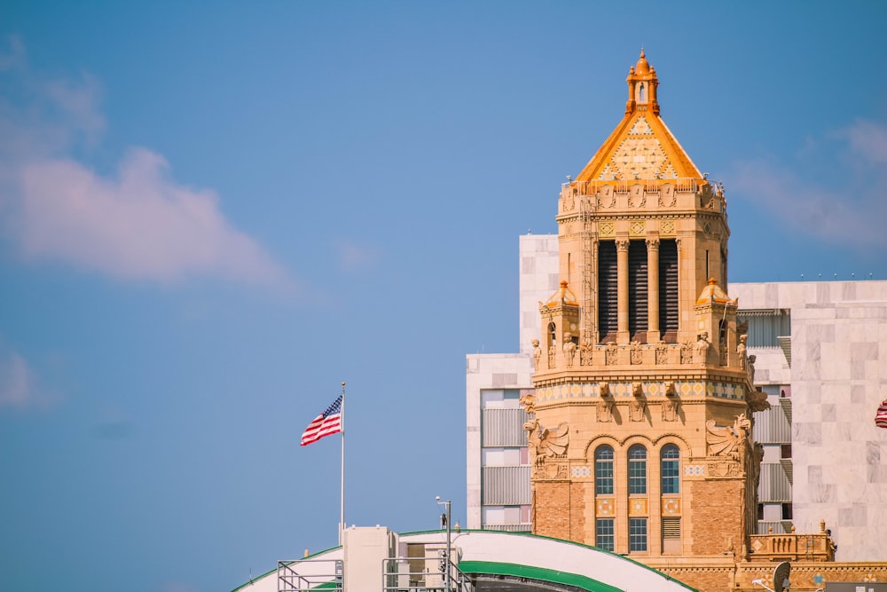 brown concrete building with flag of us a during daytime