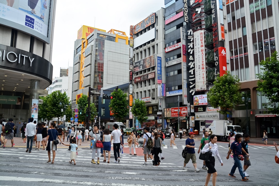 people walking on pedestrian lane near high rise buildings during daytime