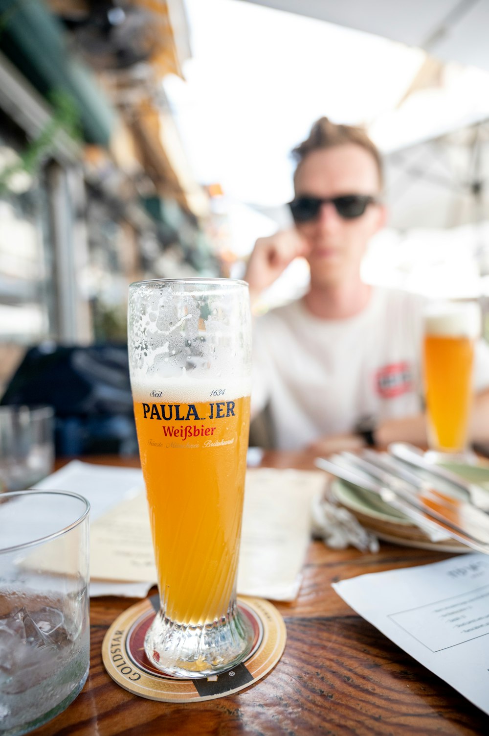 clear drinking glass with beer on brown wooden table