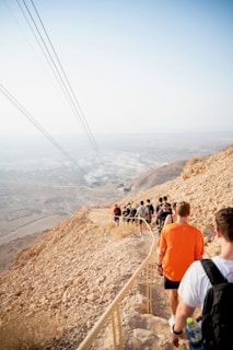 people walking on brown mountain during daytime