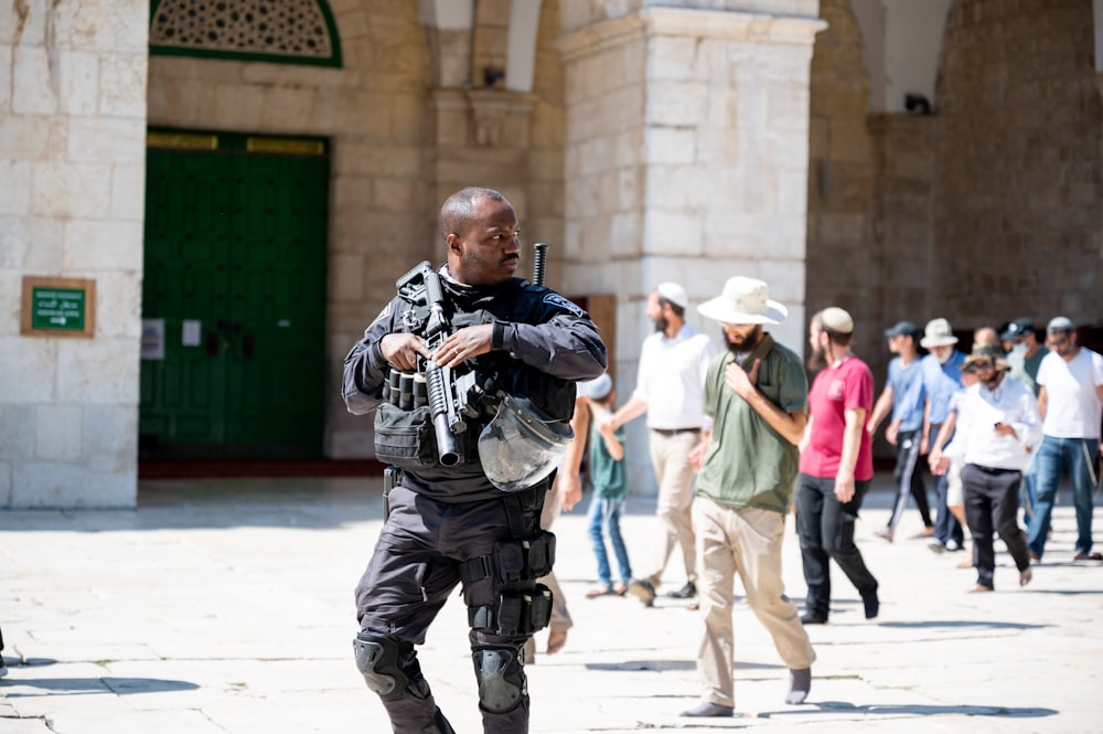 man in blue denim jeans carrying black dslr camera