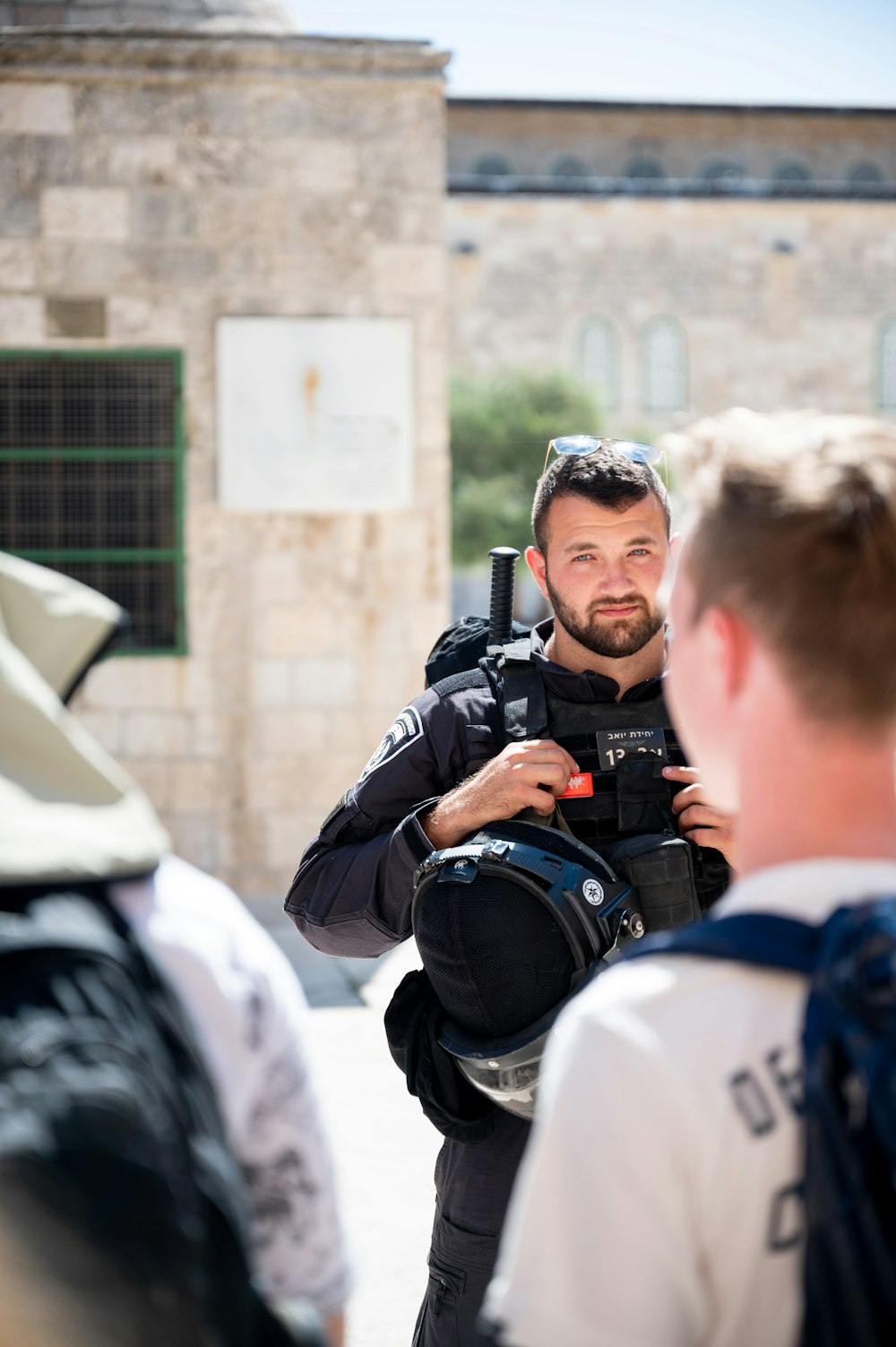 man in blue and white shirt holding black dslr camera