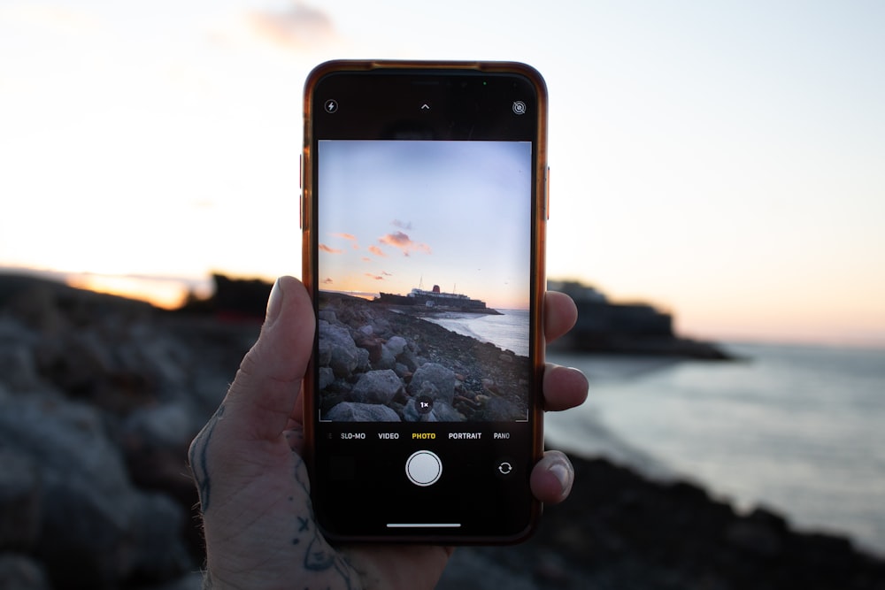 person holding black iphone 4