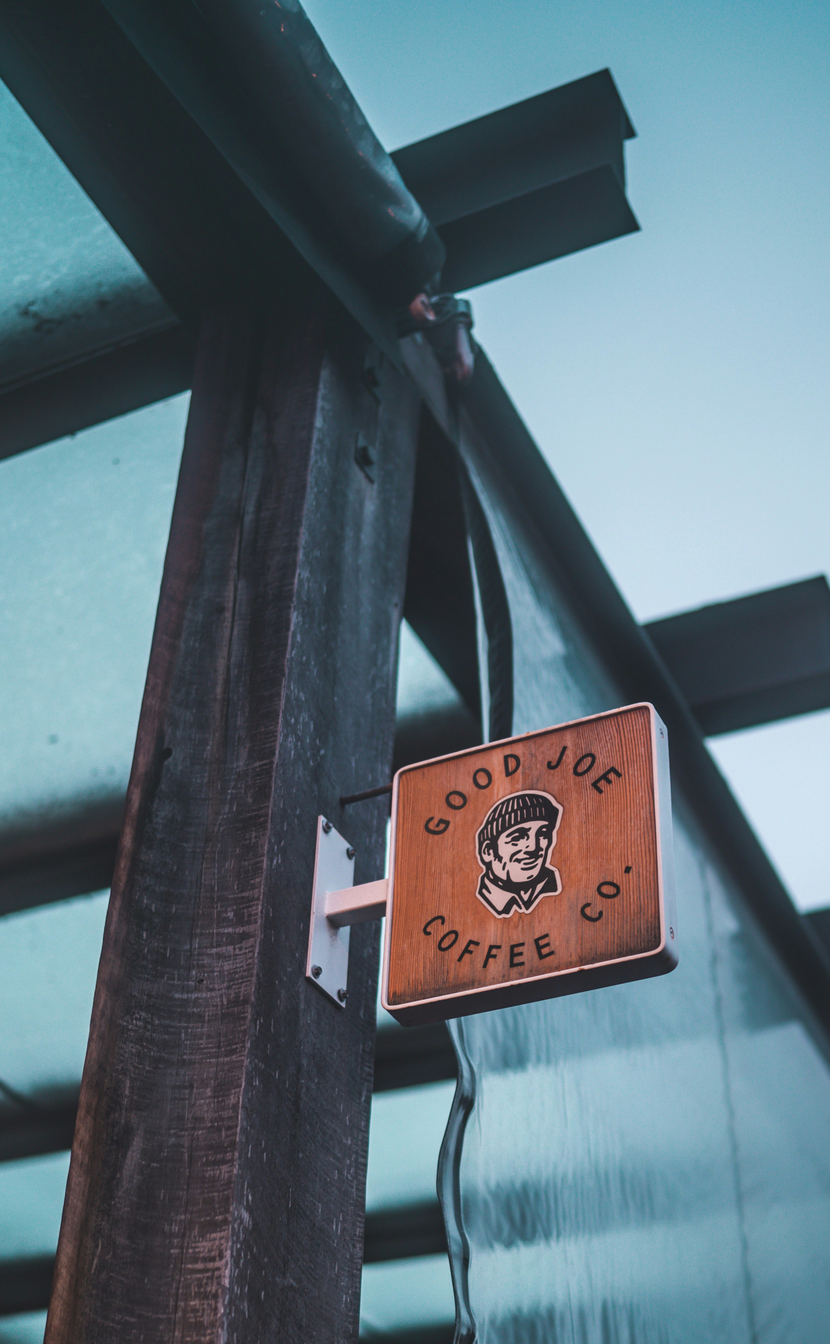 brown wooden signage on wooden post