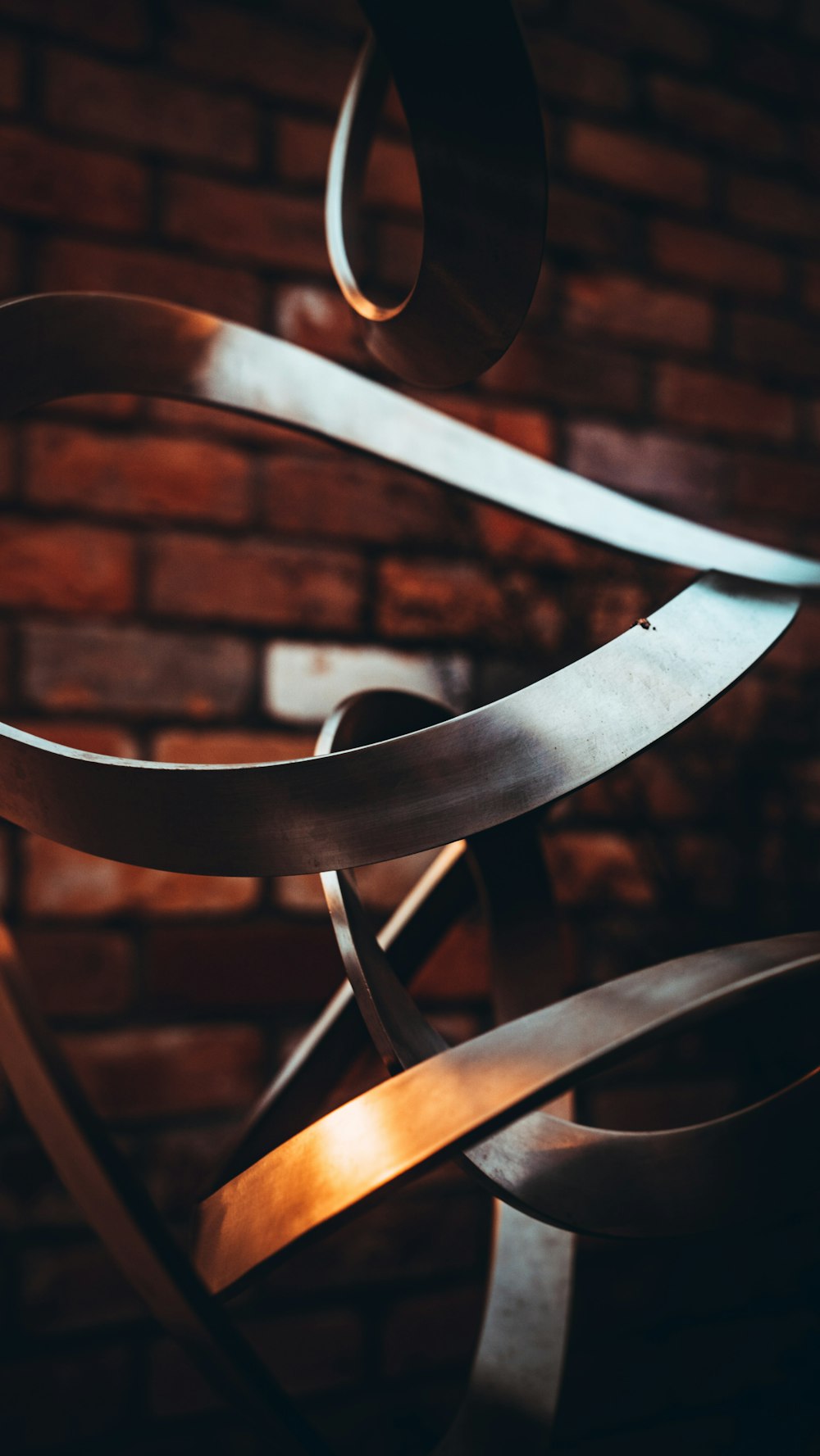 brown wooden spiral staircase near brown brick wall