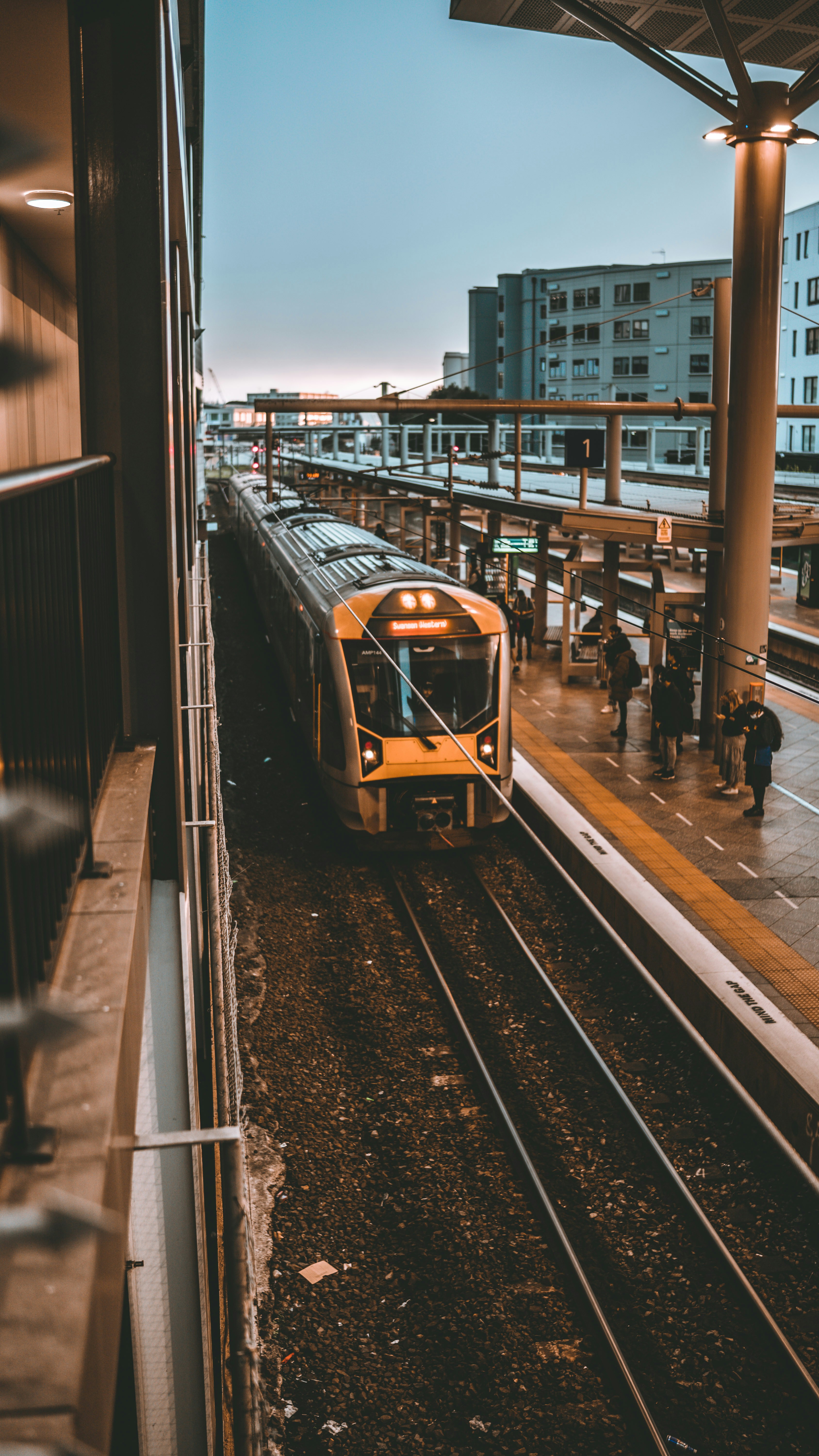yellow and black train on rail road during daytime