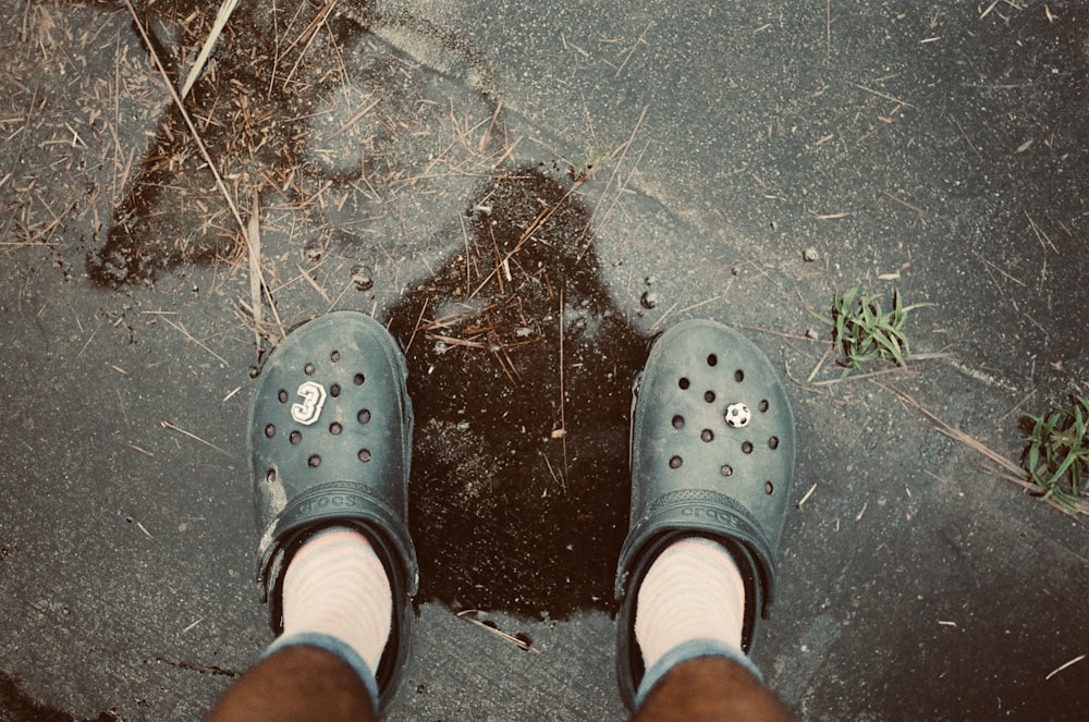 person wearing gray rubber clogs