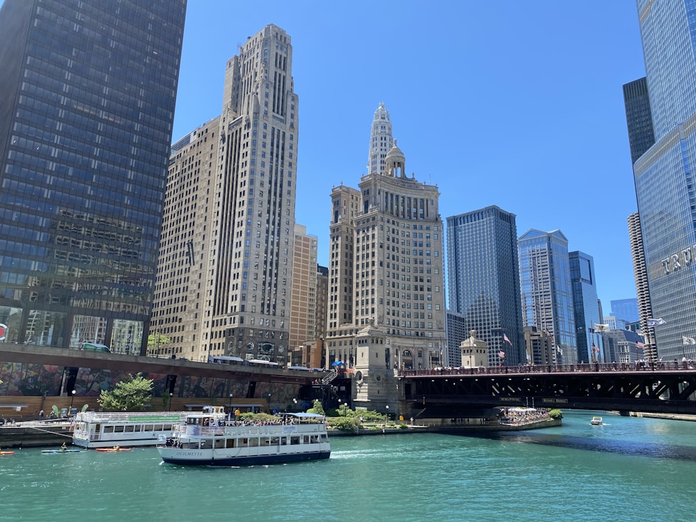 white and black boat on water near city buildings during daytime