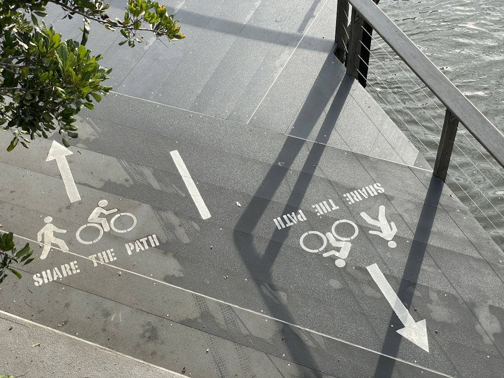 gray concrete pavement with black metal railings