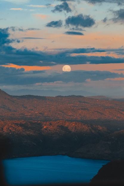 brown mountains under white clouds during daytime