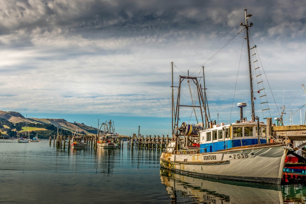 white and blue boat on sea during daytime