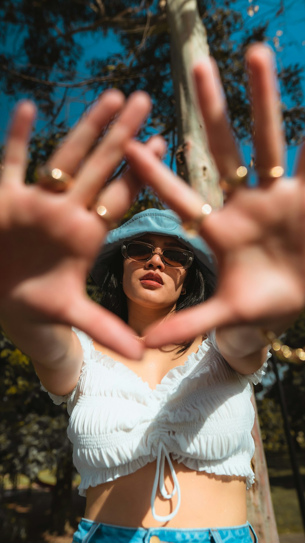 woman in white tank top wearing black sunglasses