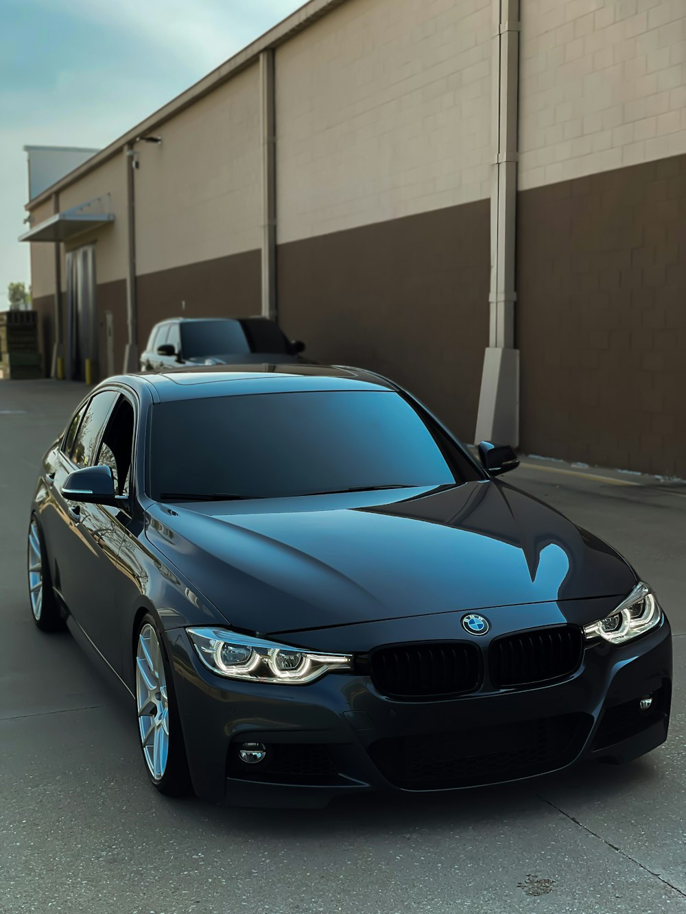 blue bmw m 3 coupe parked on parking lot during daytime