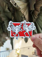 person holding red and white playing card
