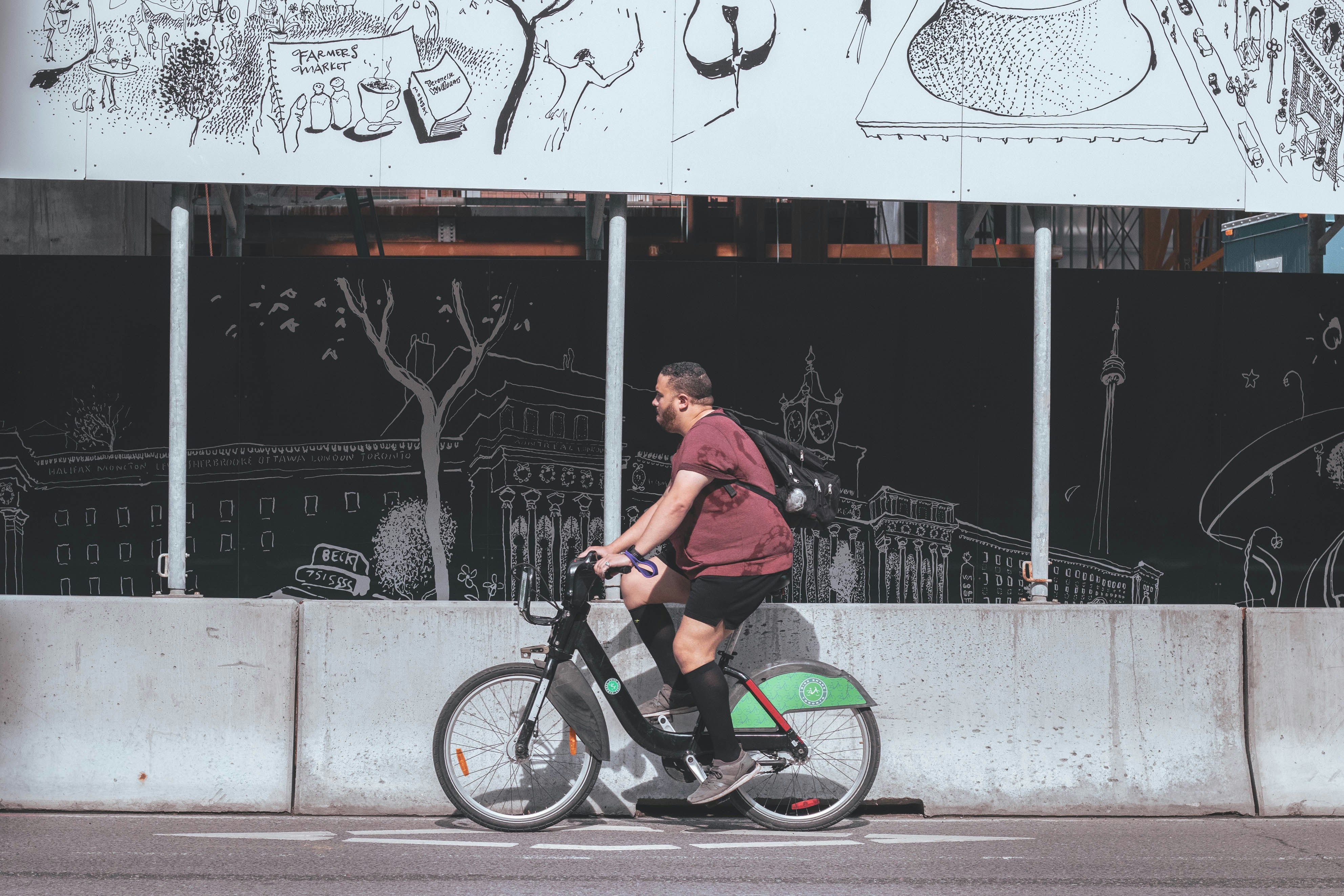 man in brown shirt riding on black bmx bike