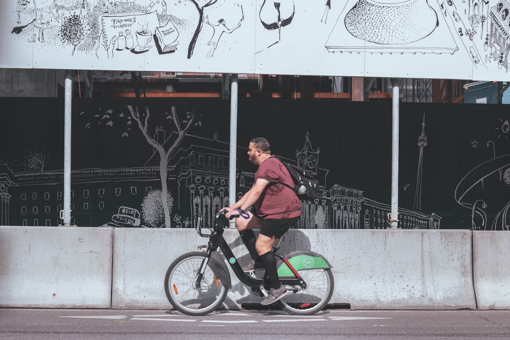 man in brown shirt riding on black bmx bike