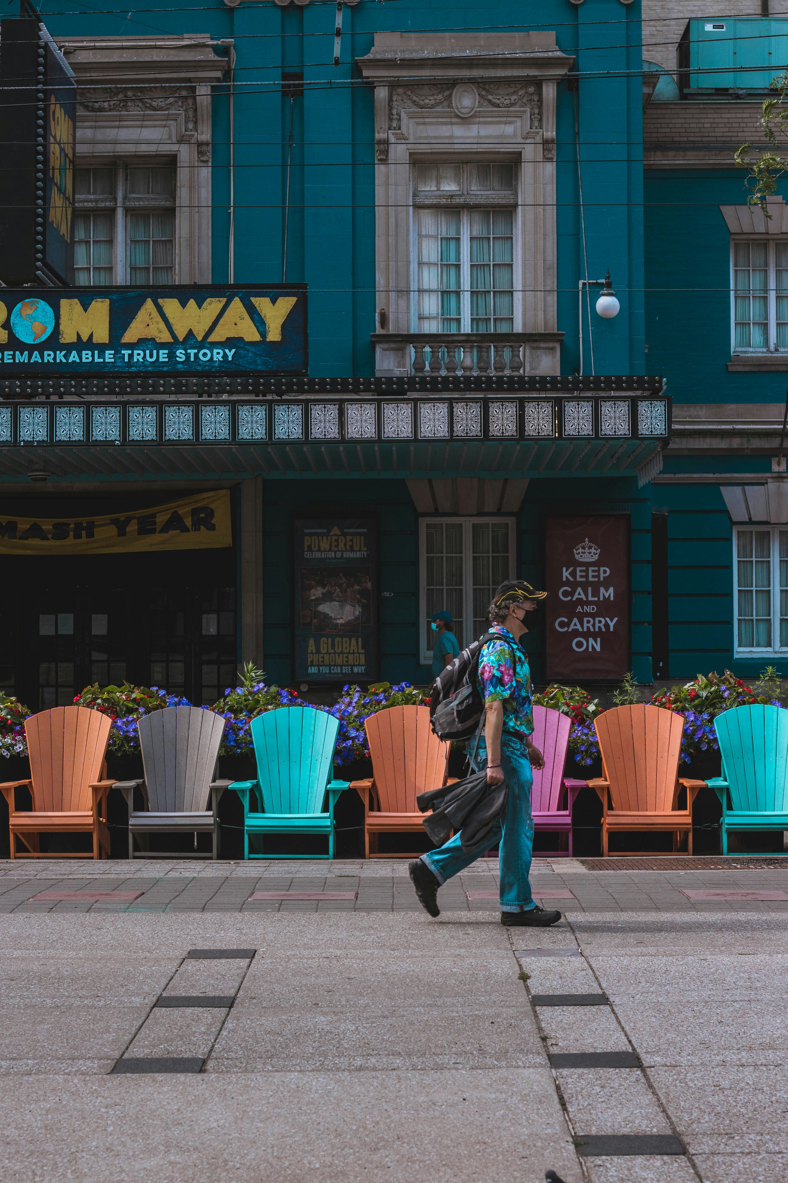 man in black jacket and black pants carrying brown wooden basket