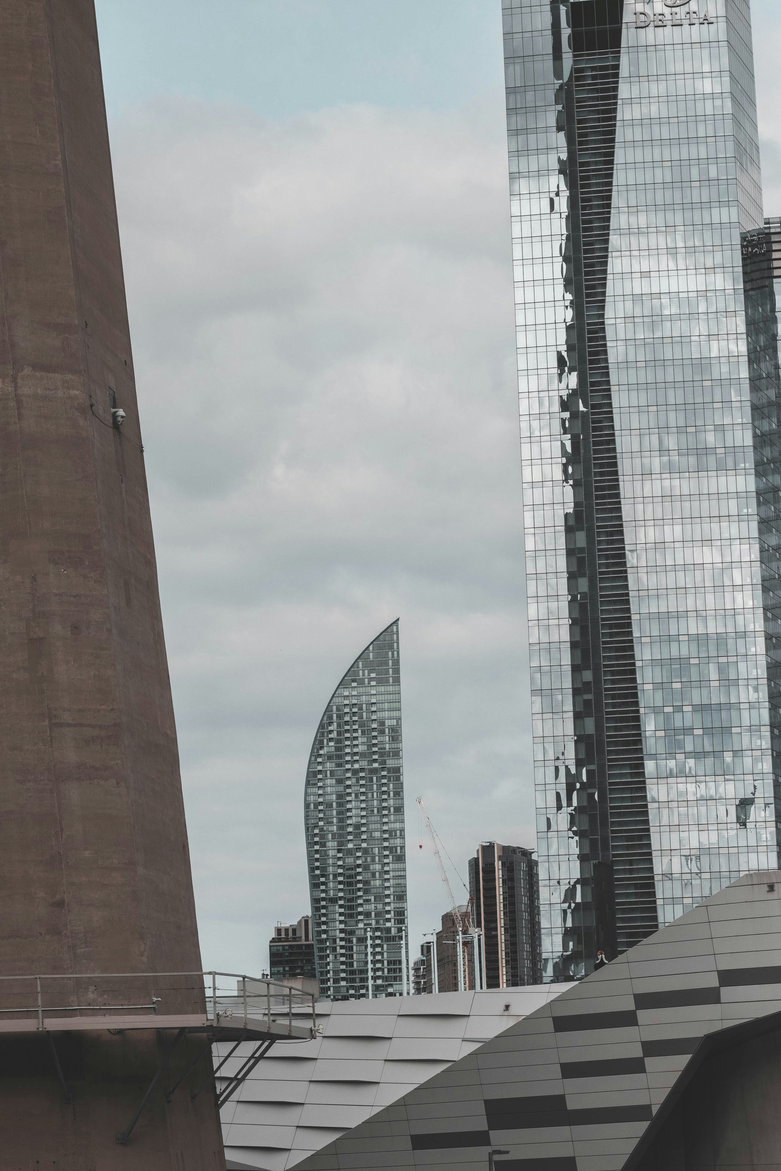 high rise buildings under white clouds during daytime