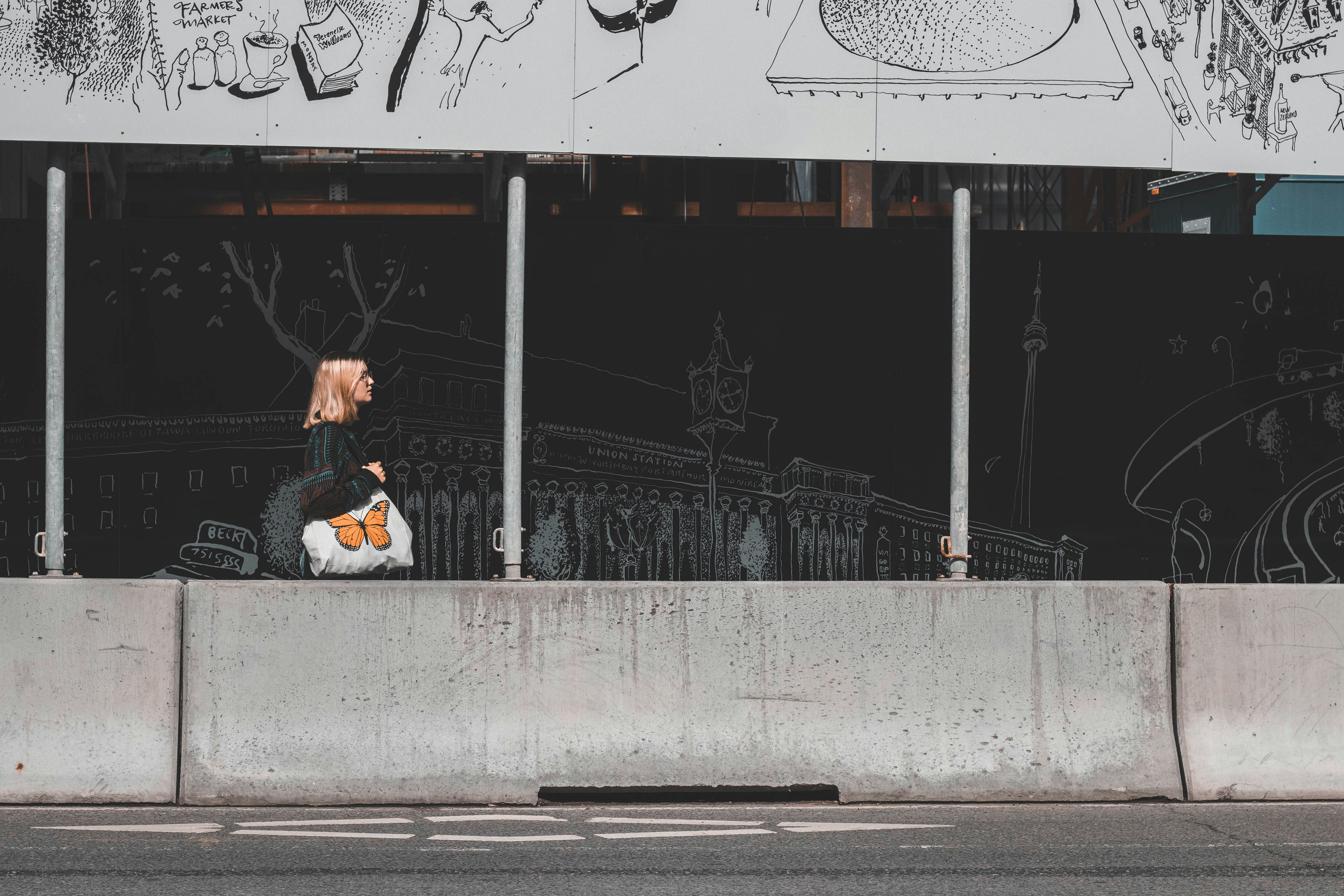 woman in white jacket sitting on gray concrete bench