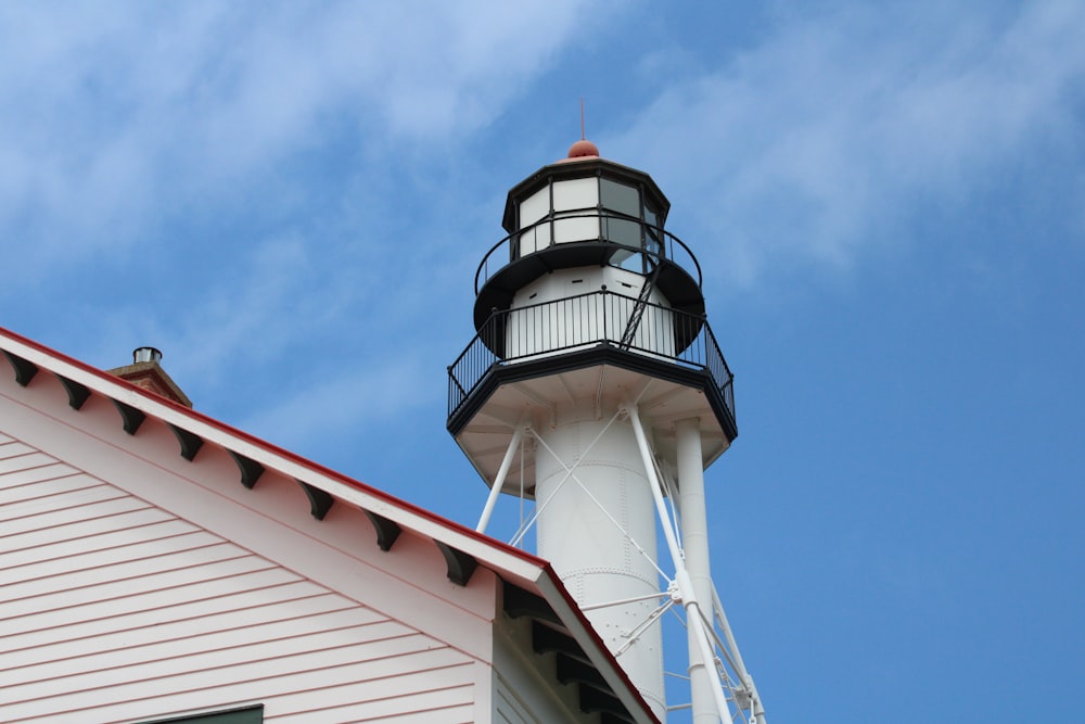 white and blue lighthouse under blue sky during daytime