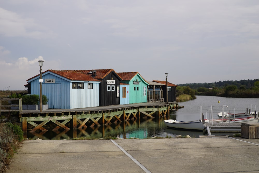 white and red wooden house on dock during daytime