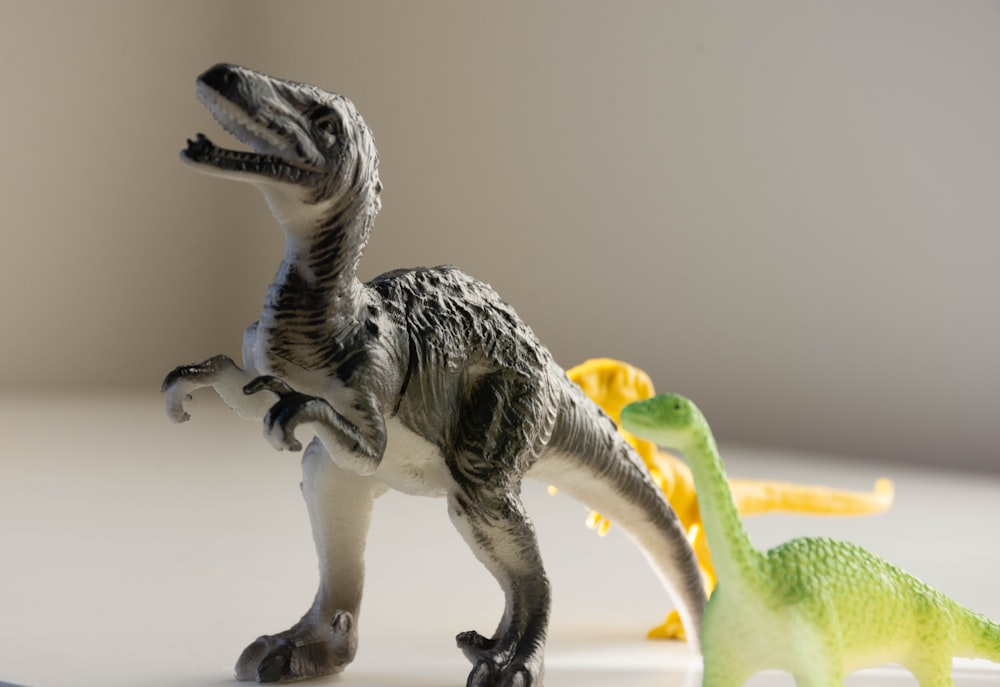 white and green dinosaur plastic toy