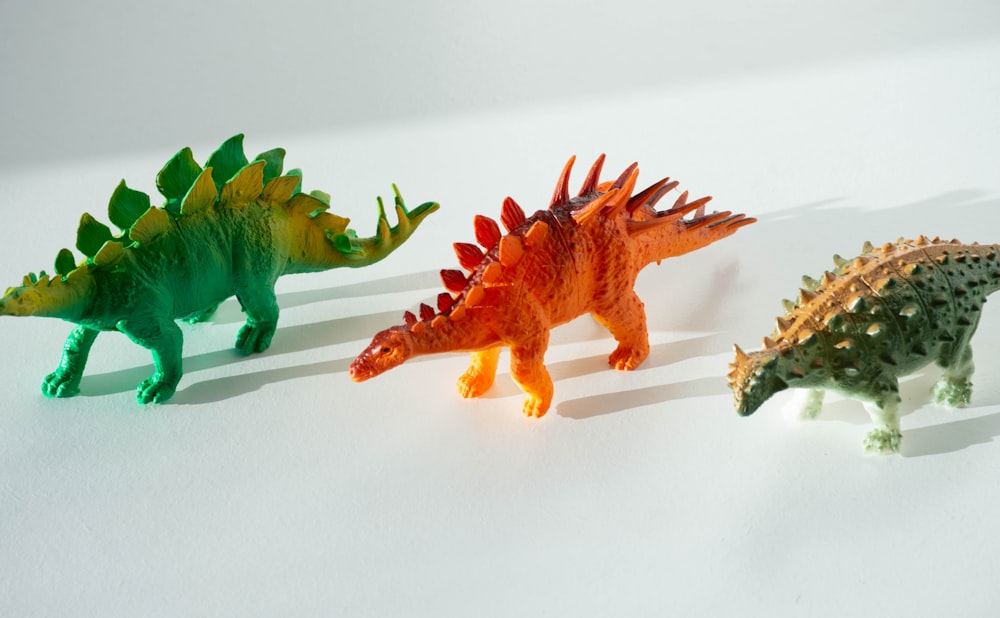 green and orange dinosaur toy