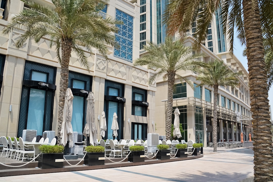 cars parked near white building during daytime