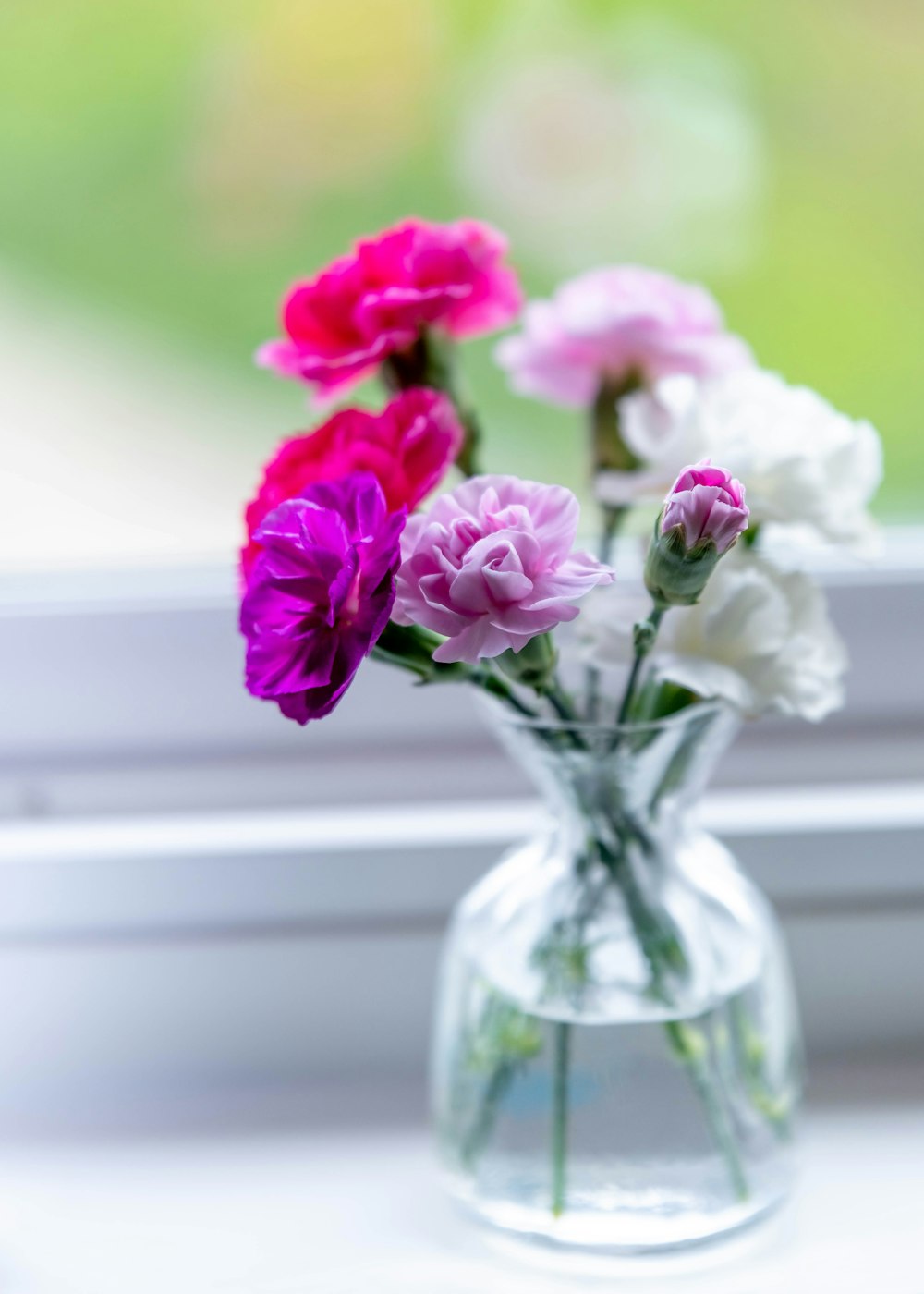 pink flowers in clear glass vase