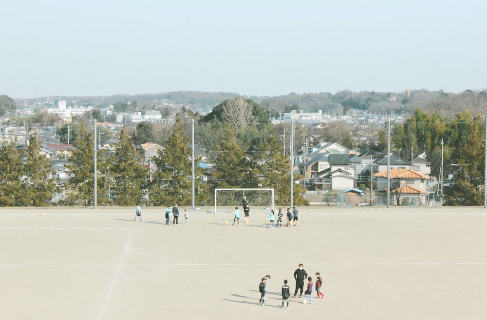 people playing ice hockey on field during daytime