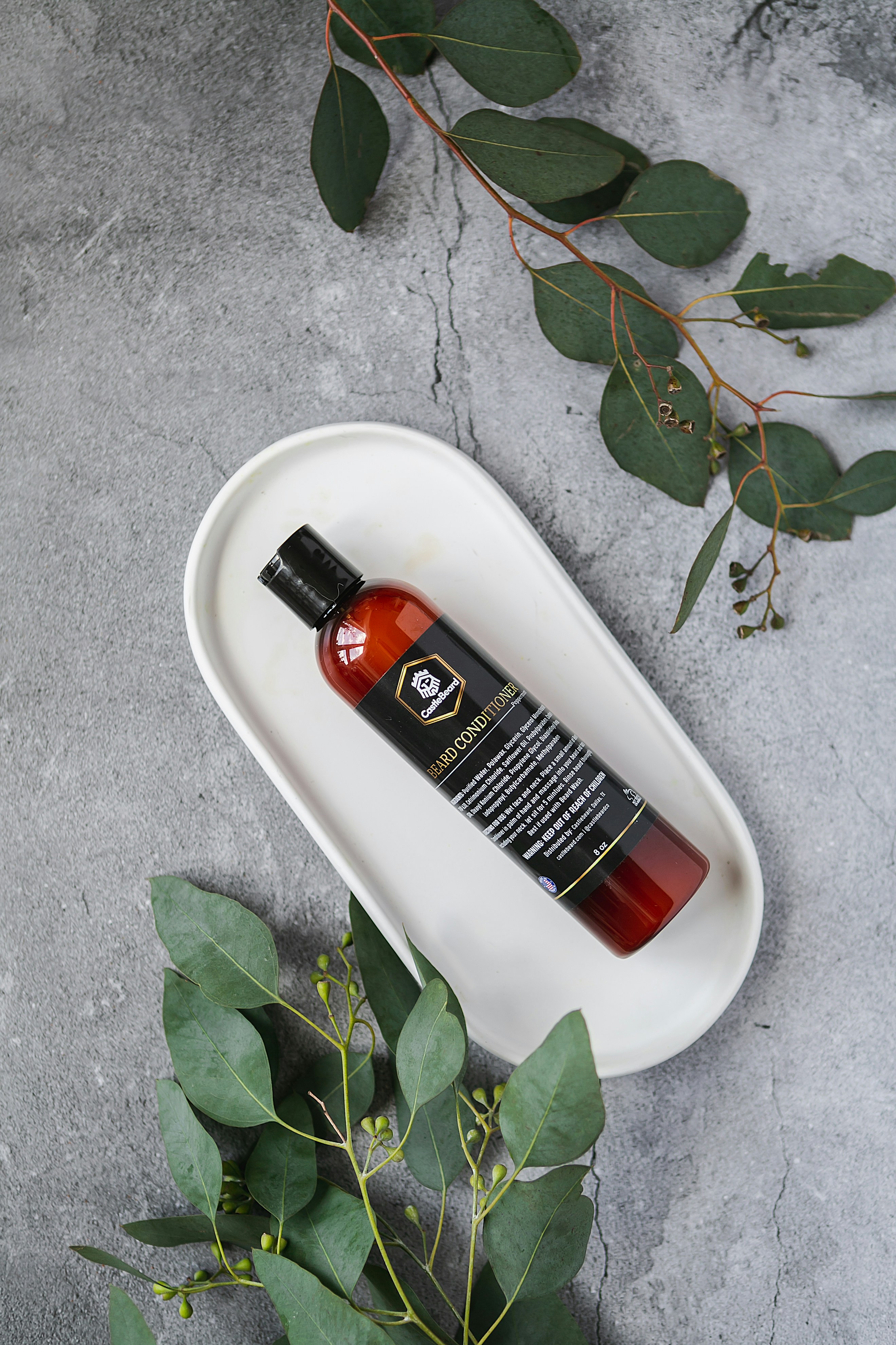 black and orange plastic bottle on white table