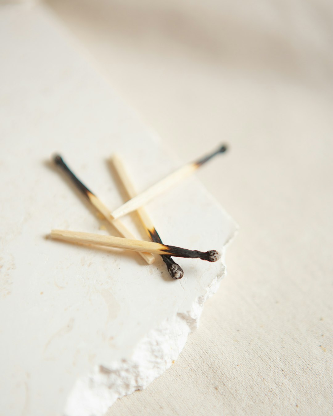  brown and white wooden sticks on white surface match stick