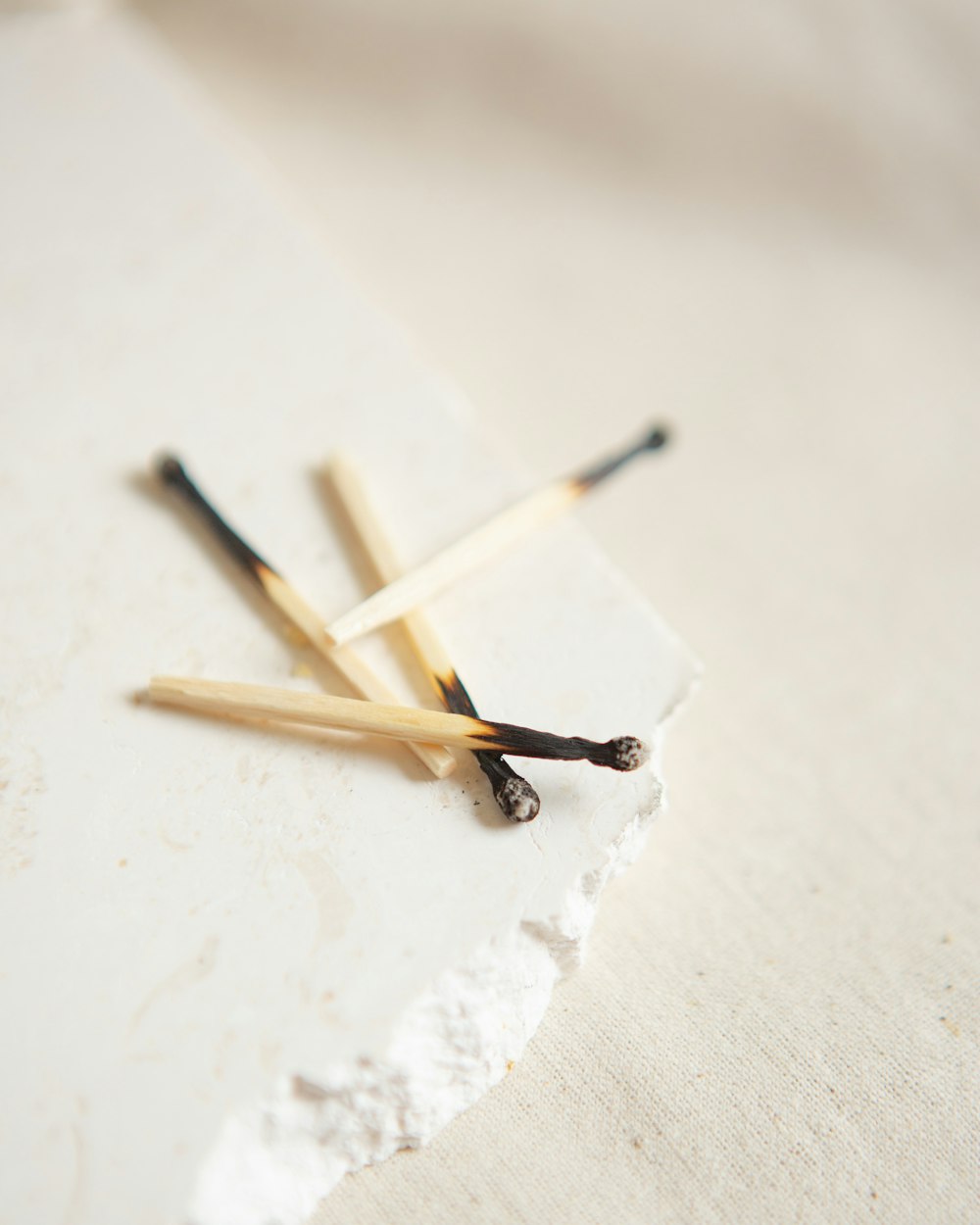 brown and white wooden sticks on white surface