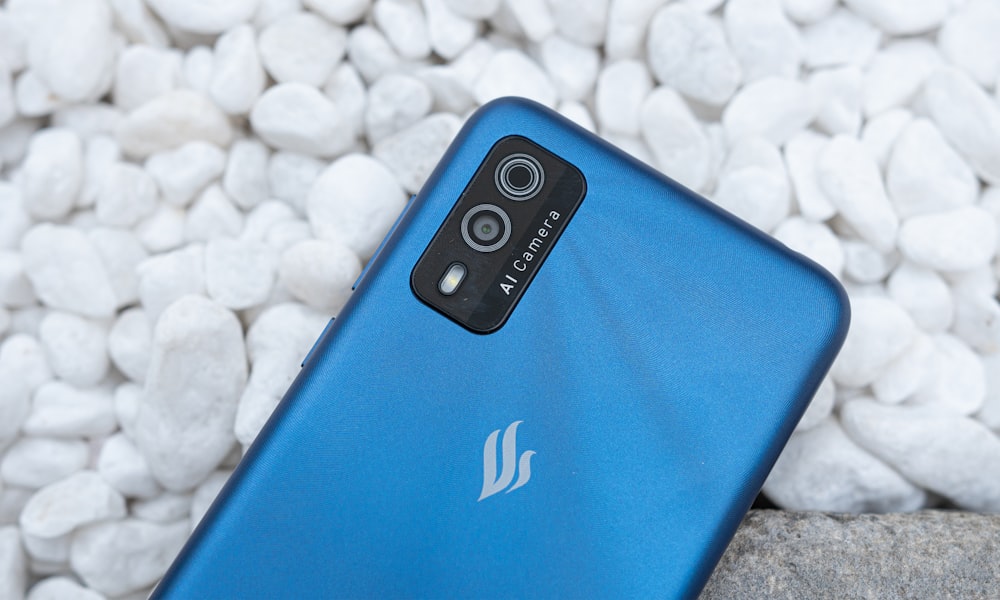 blue smartphone on white textile