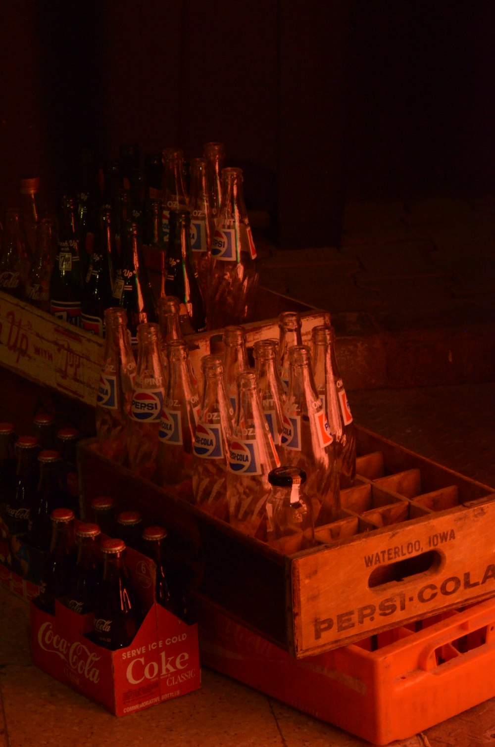 clear glass bottles on brown wooden crate