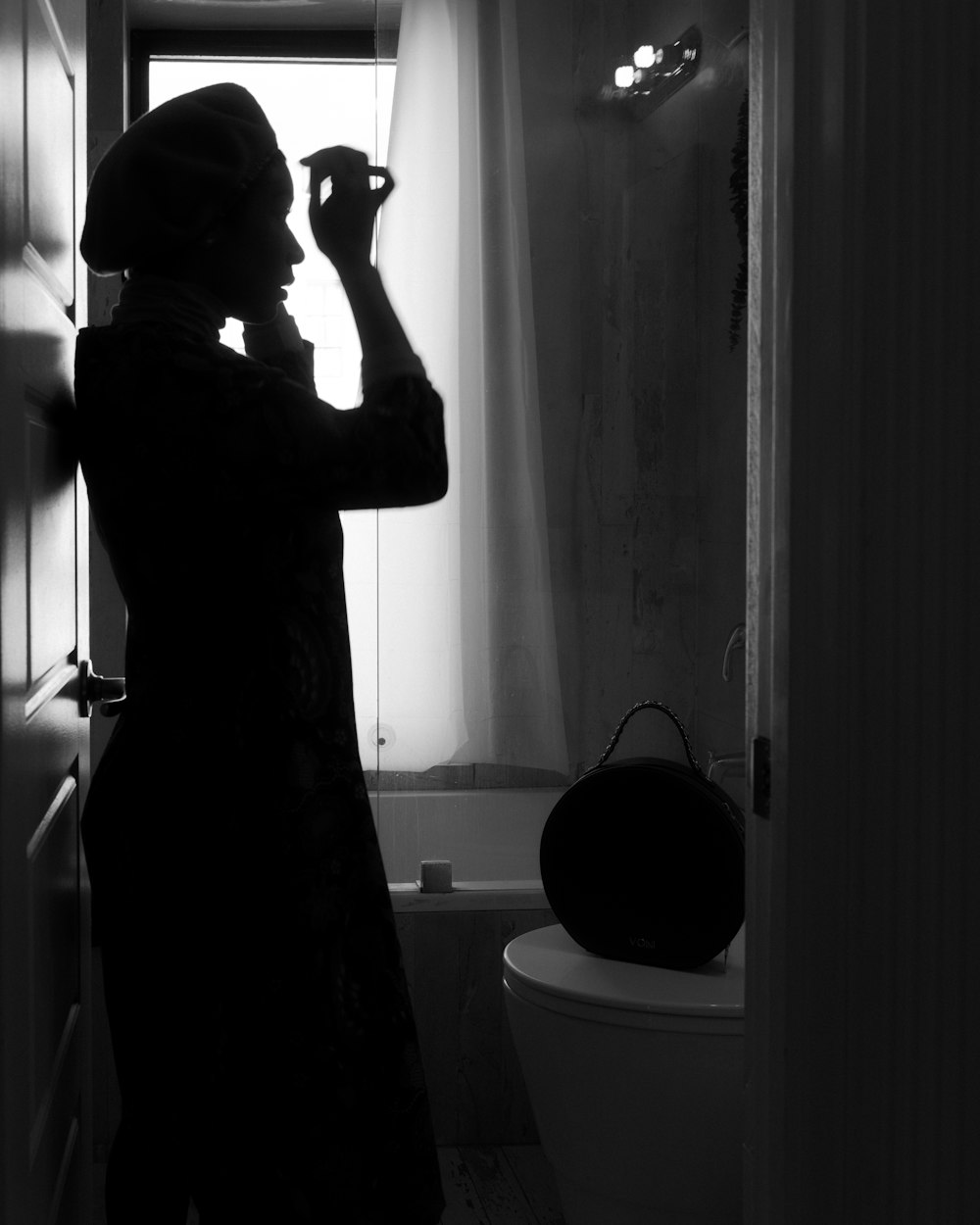 man in black t-shirt standing in front of mirror