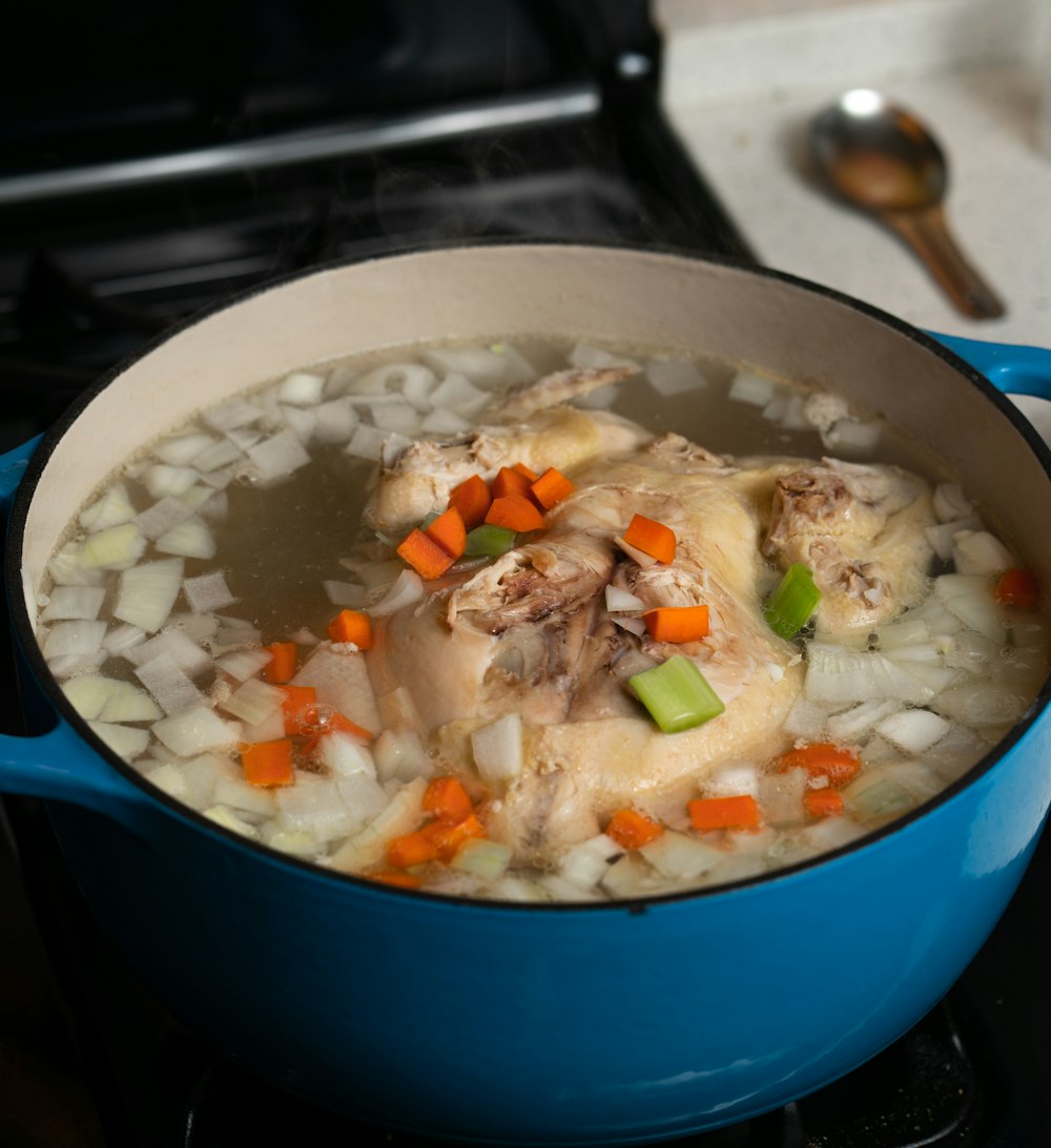 white rice with green peas and carrots in blue ceramic bowl