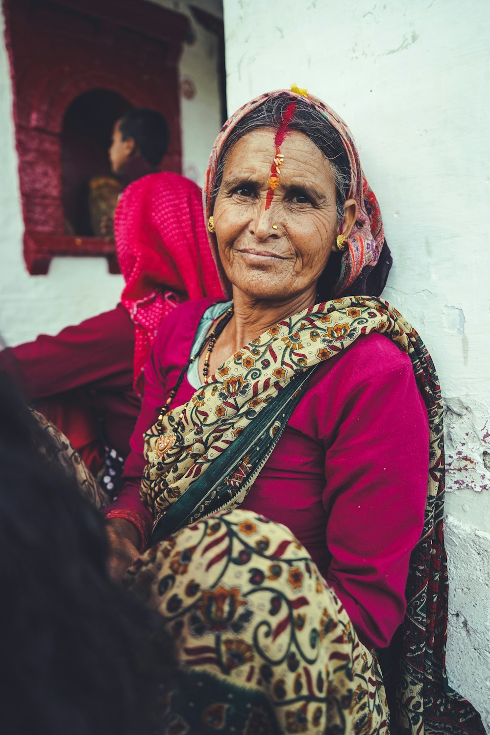 woman in red and brown hijab