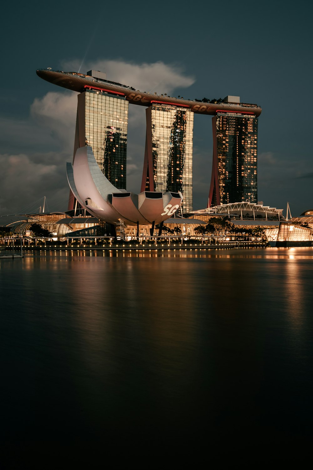 white and brown building near body of water during night time