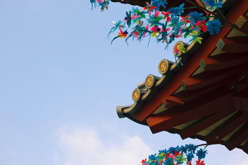 brown wooden roof with pink and white flowers